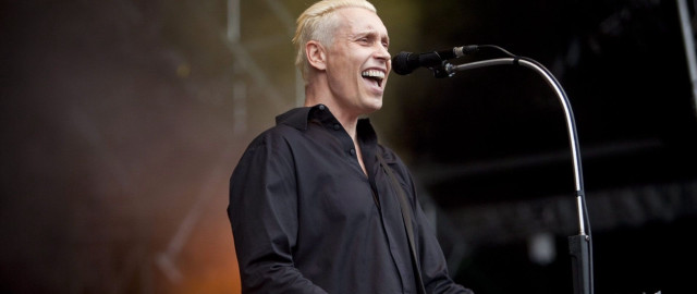 Man standing microphone black shirt free wallpaper for desktop - medium preview image