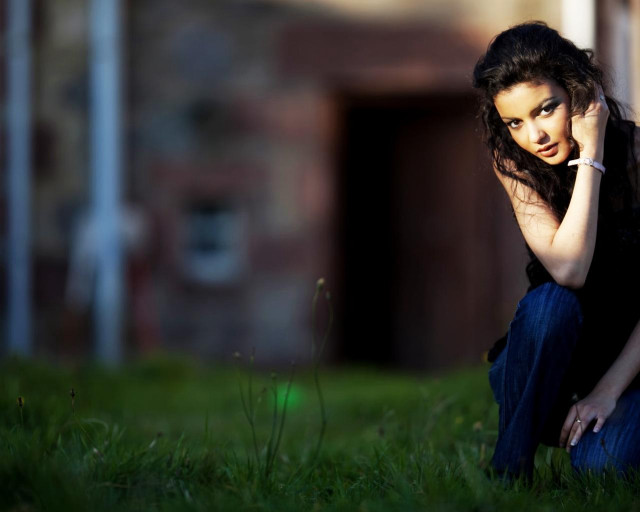 Woman sitting grass talking cellphone free wallpaper for desktop - medium preview image