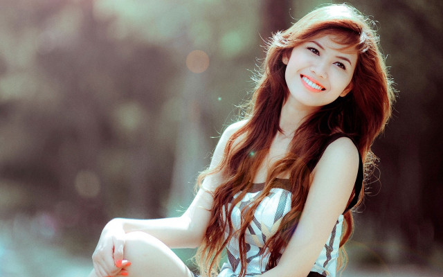 Woman smiling pencil sitting ground free wallpaper for desktop - medium preview image