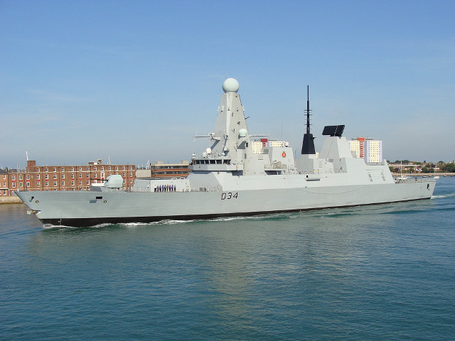 Military ship sailing city skyline free wallpaper for desktop - medium preview image