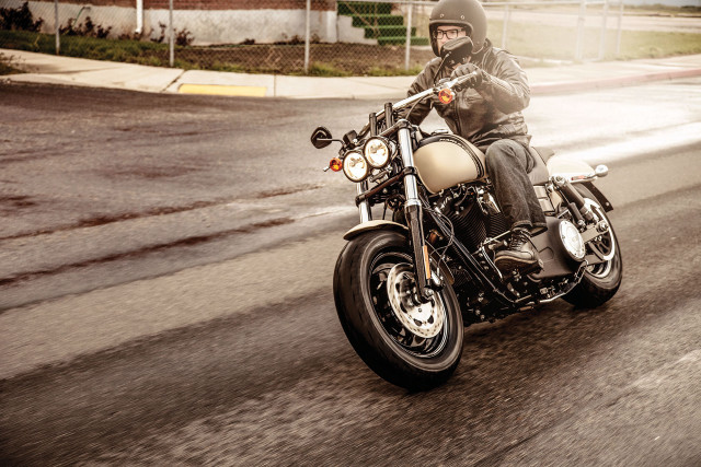 Man motorcycle street sign building free wallpaper for desktop - medium preview image