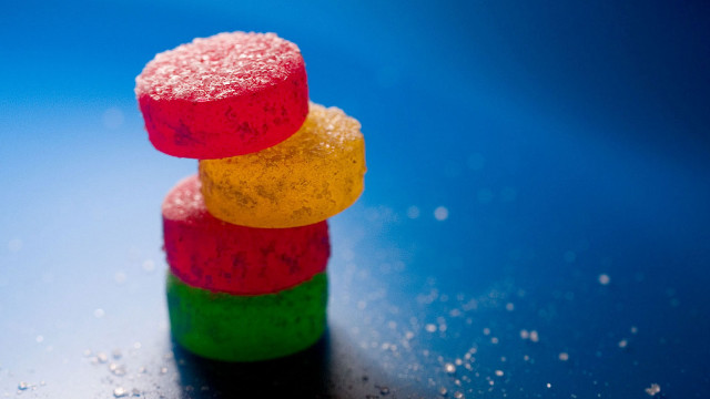 Colorful candies stack blue surface free wallpaper for desktop - medium preview image