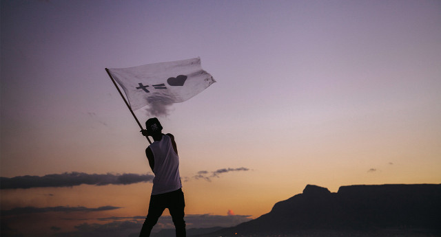 Man holding flag beach sunset free wallpaper for desktop - medium preview image