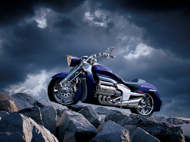Motorcycle parked rocky hill cloudy free wallpaper for desktop - medium preview image