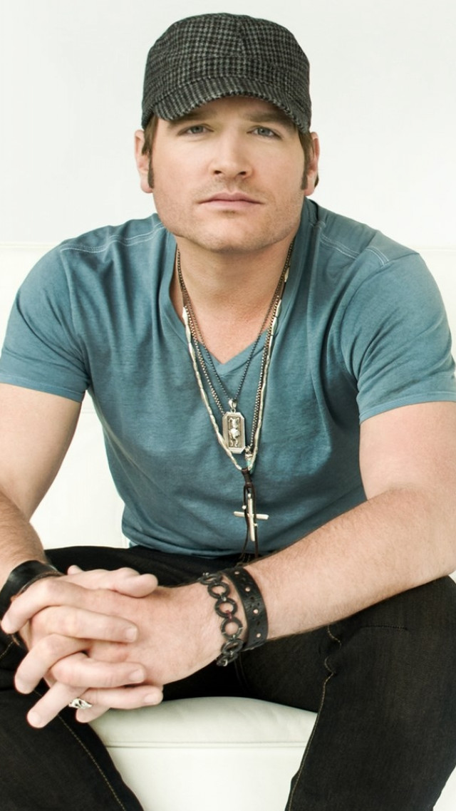 Man sitting white couch hat #2 free wallpaper for mobile - medium preview image