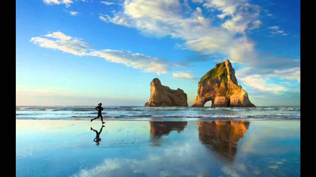 Beach walking person rock formation free wallpaper for desktop - medium preview image