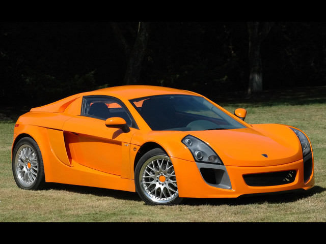 Bright orange sports car grass free wallpaper for desktop - medium preview image