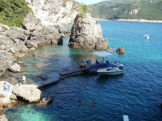 Boat docked rocky shore people free wallpaper for desktop - medium preview image