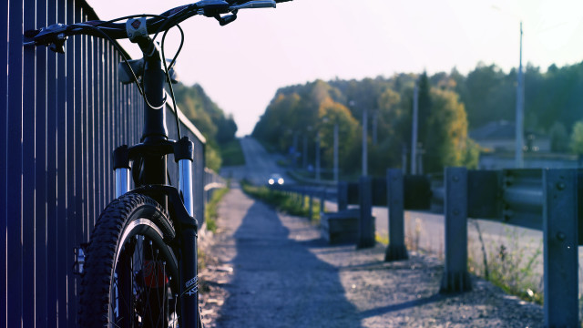 Bike parked fence roadside trees free wallpaper for desktop - medium preview image