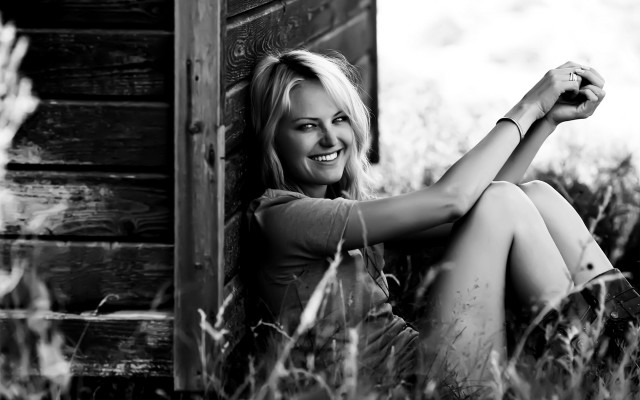 Woman sitting grass smiling camera free wallpaper for desktop - medium preview image