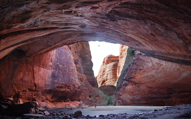 Person cave mountains sky view free wallpaper for desktop - medium preview image