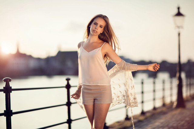 Woman shorts white top fence free wallpaper for desktop - medium preview image