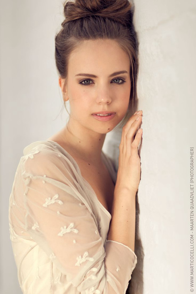 Woman bun hair leaning wall free wallpaper for mobile - medium preview image