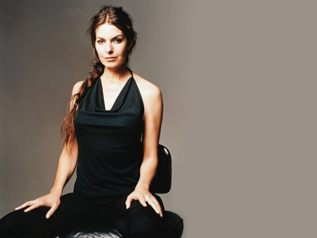 Woman sitting chair hands pockets free wallpaper for desktop - medium preview image