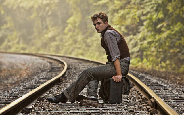 Man sitting train track suitcase free wallpaper for desktop - medium preview image