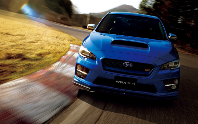 Blue subaru driving road grass free wallpaper for desktop - medium preview image