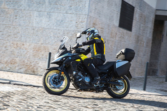 Man motorcycle cobblestone road building free wallpaper for desktop - medium preview image