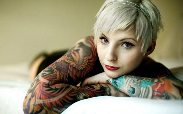 Woman tattoos bed arms crossed free wallpaper for desktop - medium preview image