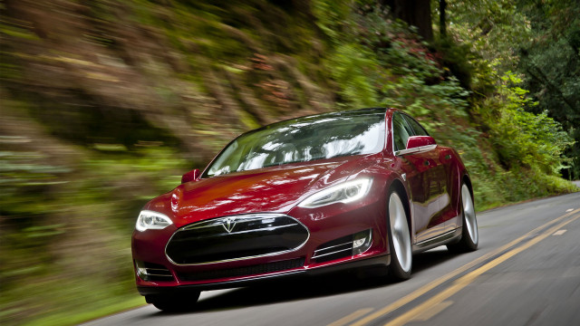 Red tesla car driving woods free wallpaper for desktop - medium preview image