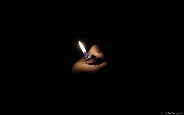 Person holding lighter dark background free wallpaper for desktop - medium preview image