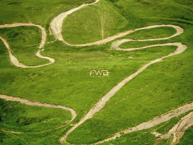 Green field white sign mountain free wallpaper for desktop - medium preview image