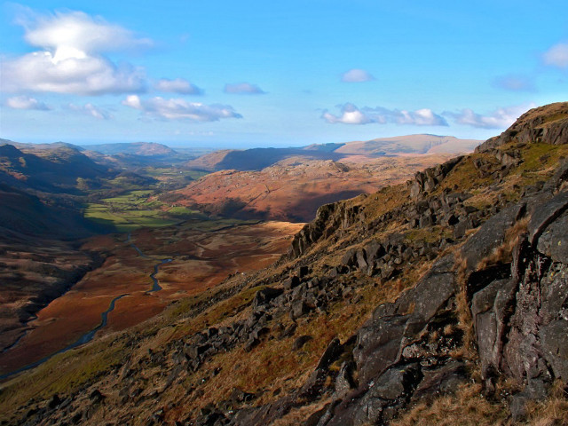 Man sitting rock mountain valley free wallpaper for desktop - medium preview image