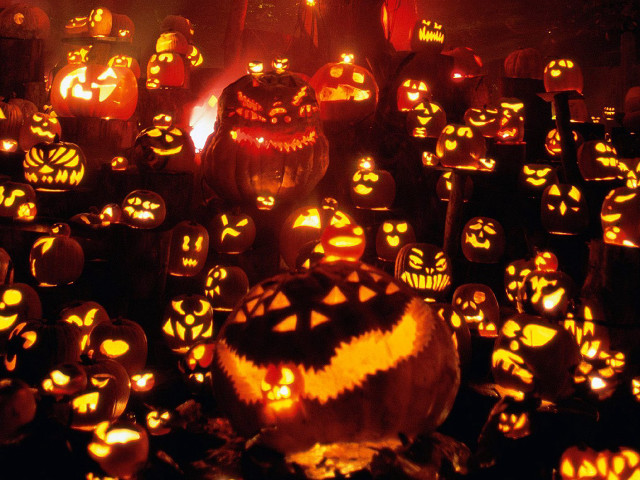 Glowing pumpkins faces dark group free wallpaper for desktop - medium preview image