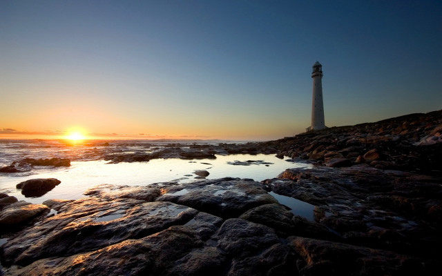 Lighthouse rocky shore sunset sun free wallpaper for desktop - medium preview image