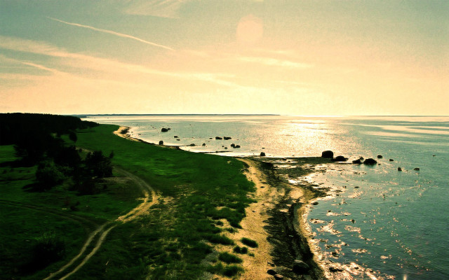 Beach grassy hill water rocks free wallpaper for desktop - medium preview image