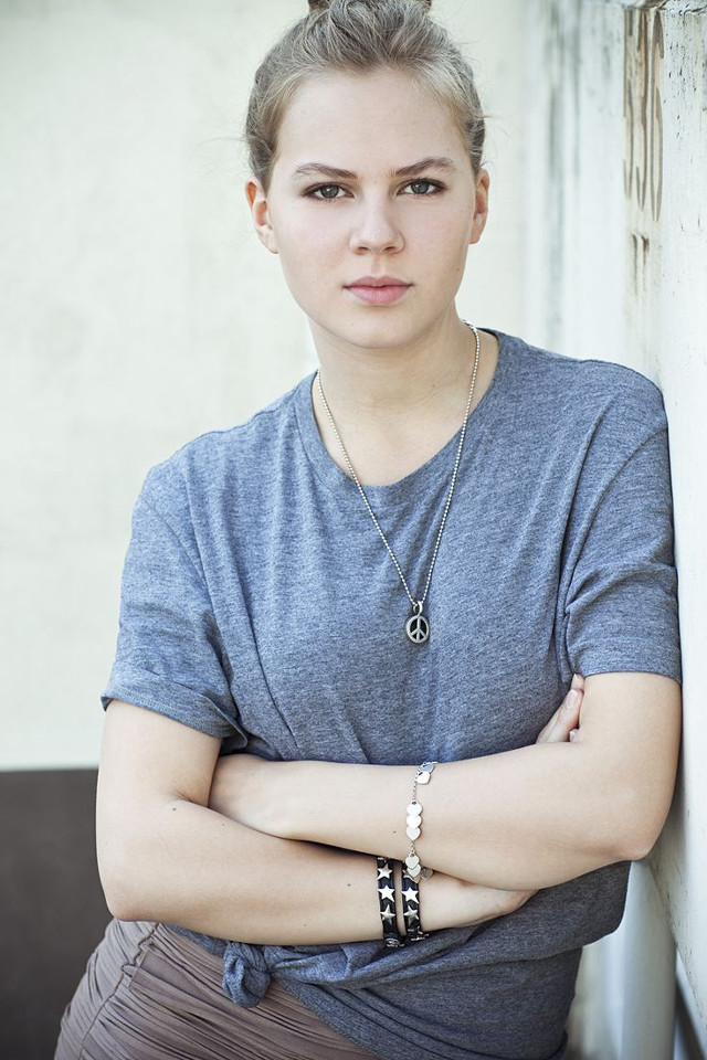 Woman arms crossed leaning wall free wallpaper for mobile - medium preview image