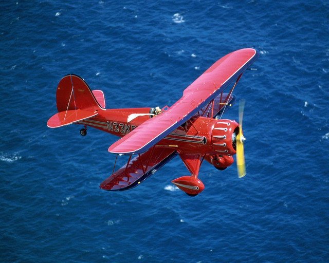 Red airplane flying ocean yellow #3 free wallpaper for desktop - medium preview image