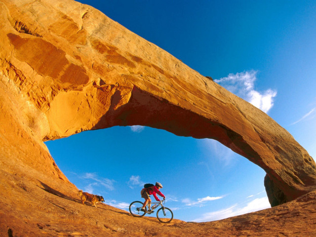 Man bike desert rock arch #4 free wallpaper for desktop - medium preview image
