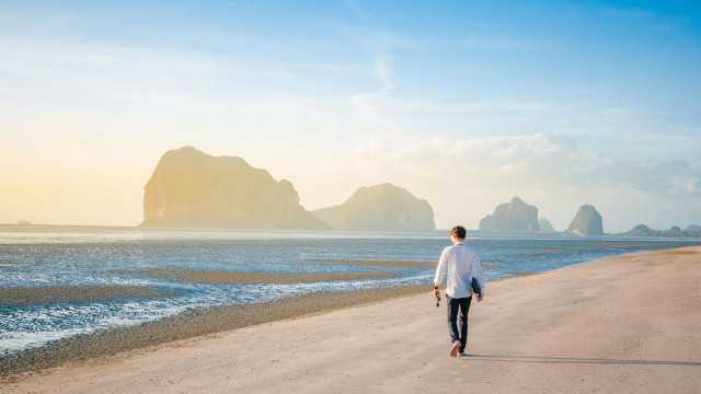 Man walking beach ocean surfboard free wallpaper for desktop - medium preview image