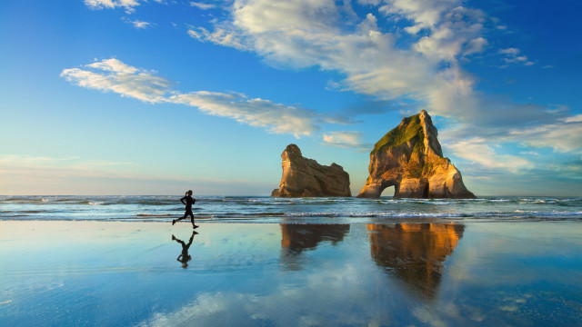Beach walking person rock formation #2 free wallpaper for desktop - medium preview image