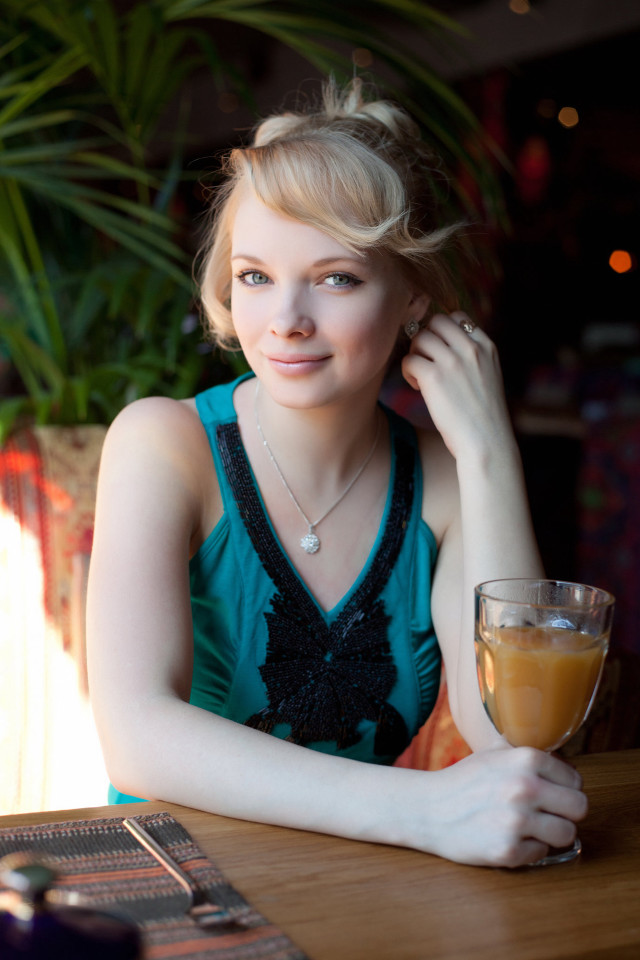 Woman sitting table orange juice #3 free wallpaper for mobile - medium preview image