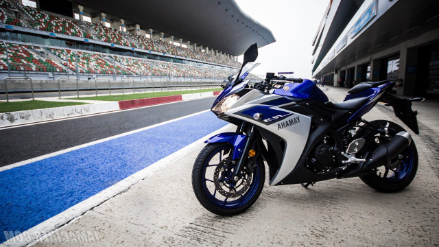 Motorcycle parked track stadium blue free wallpaper for desktop - medium preview image