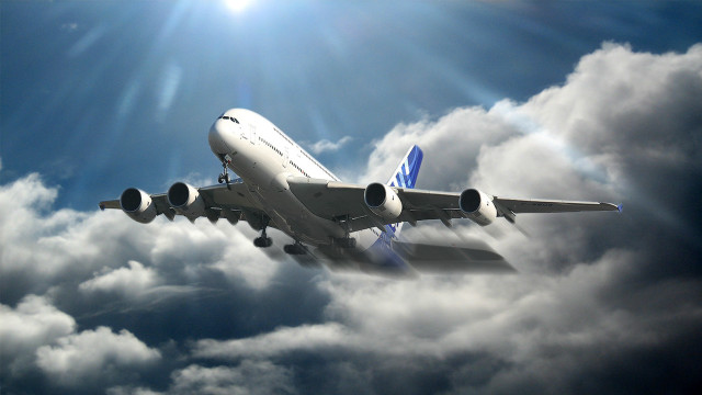 Jetliner flying cloudy sky sunbeams free wallpaper for desktop - medium preview image