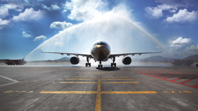 Jet airplane spraying water tarmac free wallpaper for desktop - medium preview image