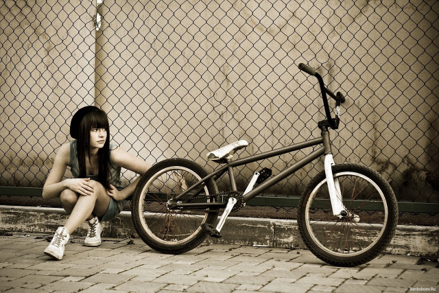 Woman bike sidewalk fence chain free wallpaper for desktop - medium preview image