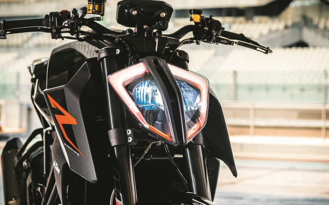 Motorcycle closeup headlight building background free wallpaper for desktop - medium preview image