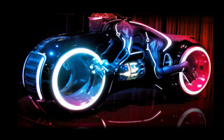 Futuristic motorcycle neon hologram planet - a neon light free wallpaper