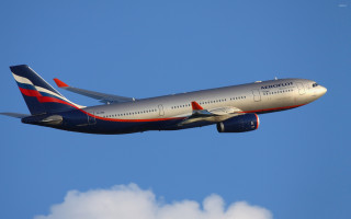 Jetliner flying blue sky clouds 13 - tail free wallpaper