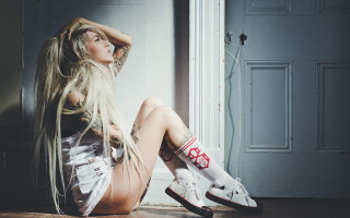 Tattooed woman blowing hair sitting - tattoo free wallpaper