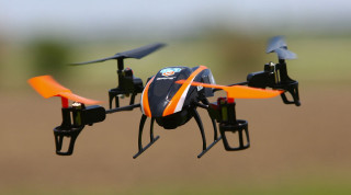Small orange black flying drone - remote free wallpaper