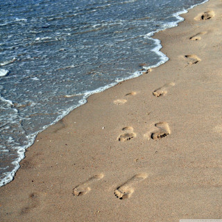 Beach wave footprints sand person - free beach wallpaper for tablet