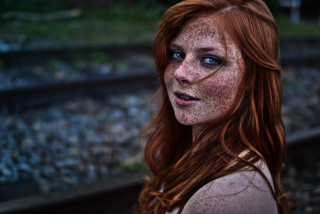 Woman freckled hair blue eyes 6 - a train track in the background free wallpaper