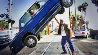 Man holding car upside down - down free wallpaper