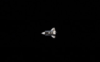 Space shuttle flying dark sky - a space shuttle free wallpaper