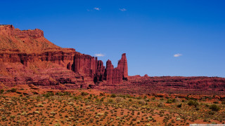 Large rock formation desert blue 2 - a large rock formation in the middle of a desert area free wallpaper