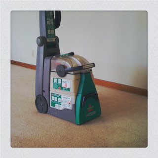 Carpet cleaner sitting floor green - a tilt shift photo free wallpaper for tablet